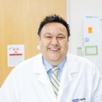 Steven Jonas smiles in a UCLA lab.