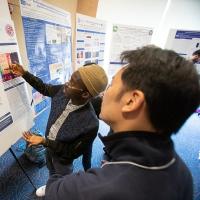 Ahmed Oyetunde (left), a former CSUN-UCLA intern in the lab of Matteo Pellegrini, presents his research project at the UCLA Broad Stem Cell Research Center’s 15th annual Stem Cell Symposium.