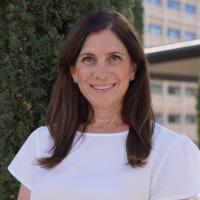 UCLA physician-scientist Aya Barzelay-Wollman smiles for a headshot outdoors.