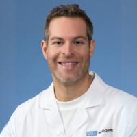 UCLA researcher Avi Samelson smiles for a headshot. 