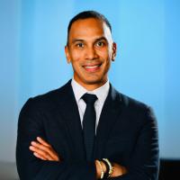 UCLA researcher Claudio Villanueva smiles for a headshot.