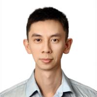 A headshot of UCLA researcher Hao Zhang, M.D. He wears a grey shirt and stands before a plain white background.