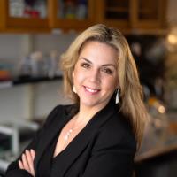 Dr. Tanya Stoyanova, a researcher at UCLA, smiles in a lab.