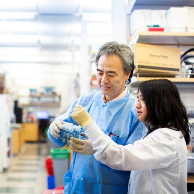 A photograph with two researchers at a UCLA Stem Cell Research Center