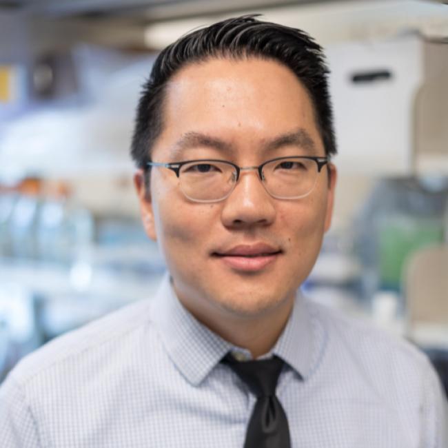 A man in a UCLA lab smiles into the camera.