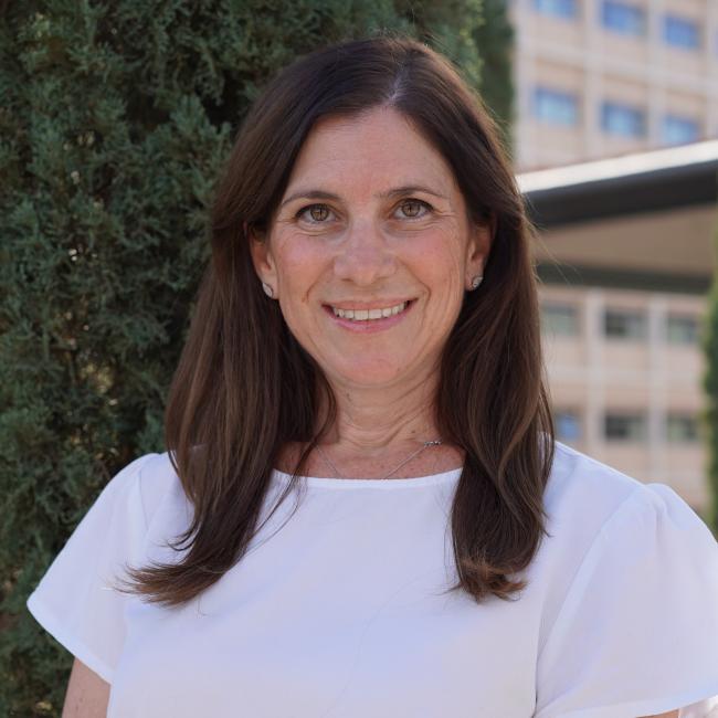 UCLA physician-scientist Aya Barzelay-Wollman smiles for a headshot outdoors.