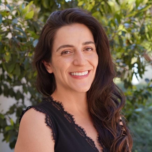 Female with long dark hair in a black shirt. 