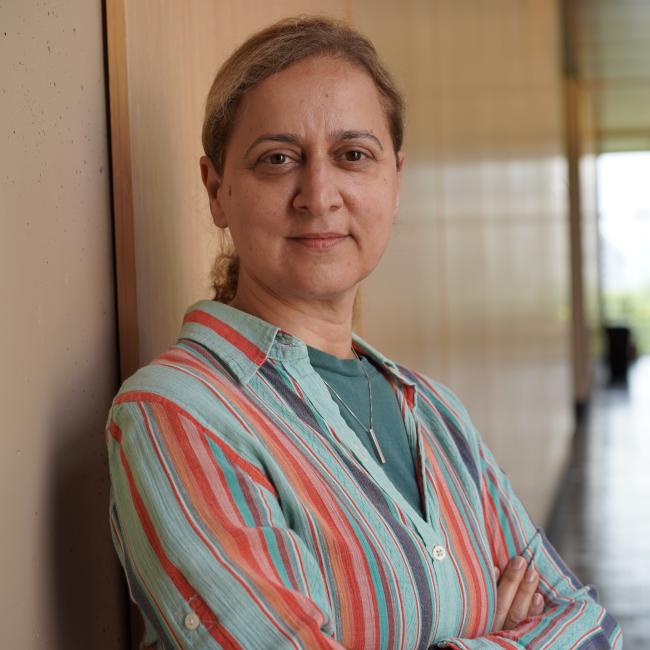 Female research associate with blonde hair wearing striped shirt.