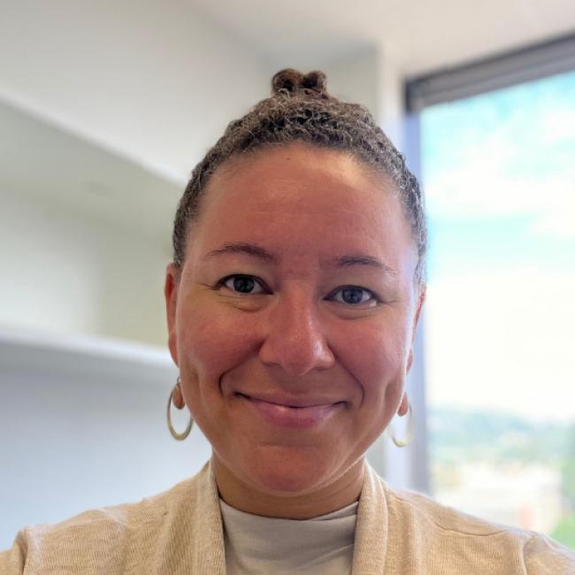 Researcher Tiki Hayes smiles for a headshot in her office