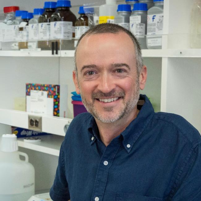 Stuart Conway smiles in a lab.