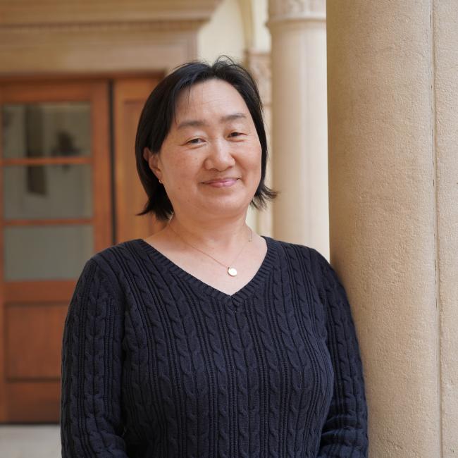 Female researcher with short dark hair wearing a black shirt.