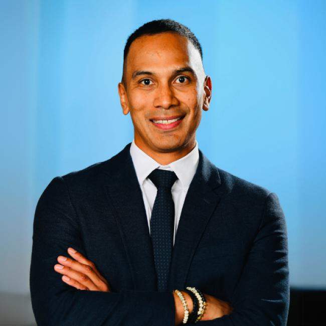 UCLA researcher Claudio Villanueva smiles for a headshot.