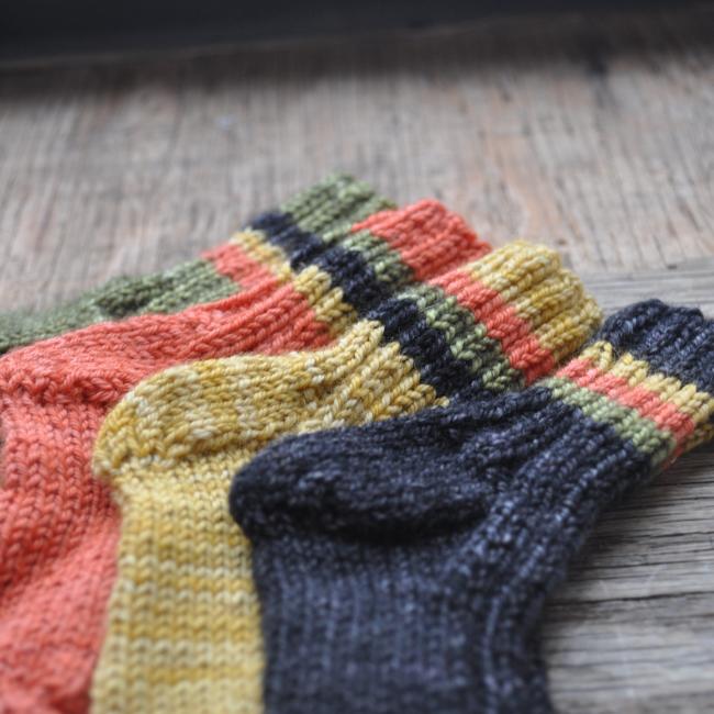 four different-colored knit socks