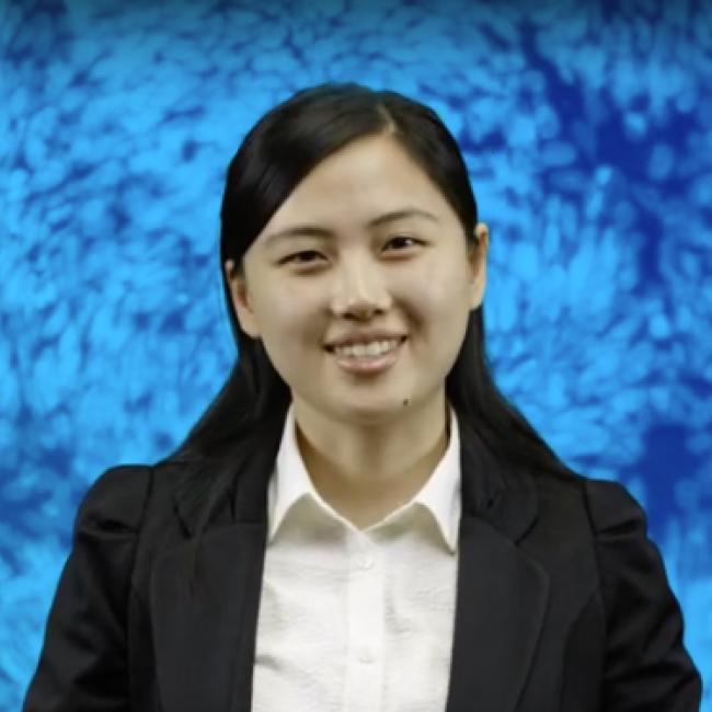 Kong, Ying smiles in a photograph against a blue background. 