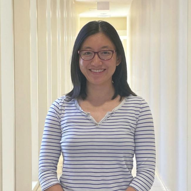 Ye Zhang smiles in a UCLA hallway.