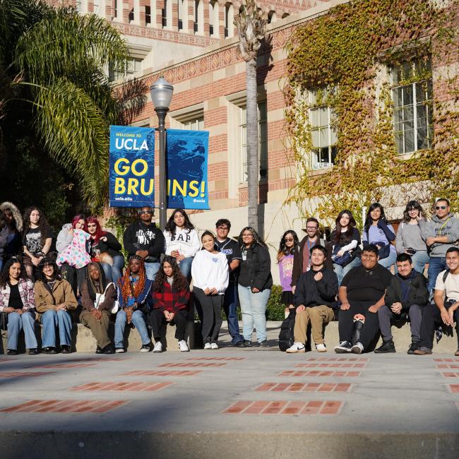 dozens of high school students sitting down in the campus center of ucla