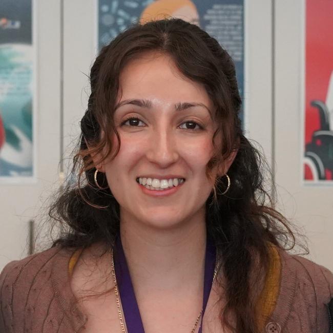 photo of high school teacher sonia perez wearing a mustard colored top and a brown cardigan